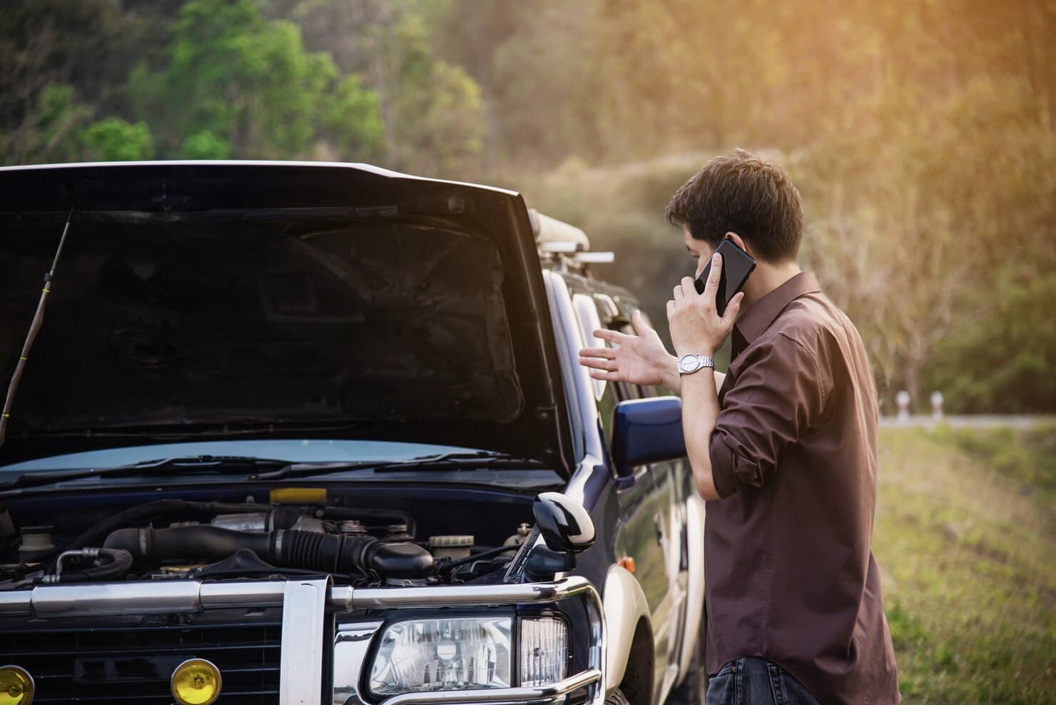 man-try-fix-car-engine-problem-local-road